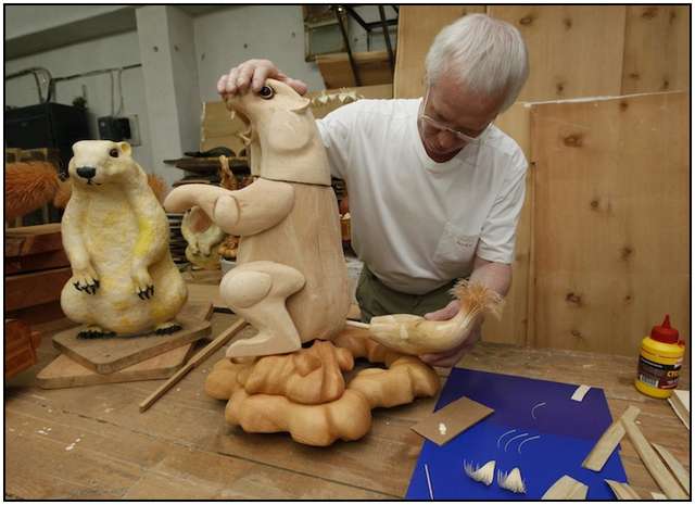 Artist Sergei Bobkov, 55, creates a life-sized sculpture of an Asian marmot made of cut chips at a workshop in a cellar of a local school in Kozhany