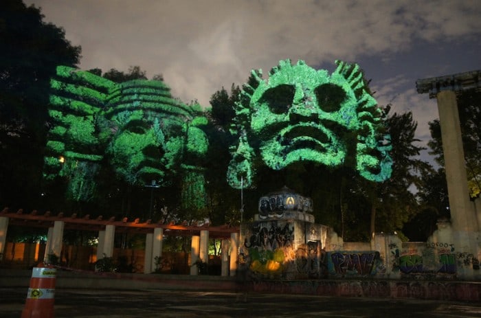 Dioses del Maíz (Corn Gods): Prehispanic 3D Gods projected on trees against transgenic corn. Dioses del Máiz (Corn Gods) is an audiovisual installation that was displayed for the first time at Foro Lindbergh, Parque México, México DF, during the 12º Corredor Cultural Roma-Condesa. The objective of this urban intervention on trees it was raising awareness about the necessity of preserving traditional Mexican corn seeds against transgenic products that threats corn variety.