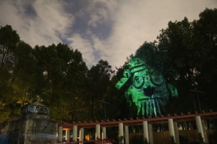 Dioses del Maíz (Corn Gods): Prehispanic 3D Gods projected on trees against transgenic corn.