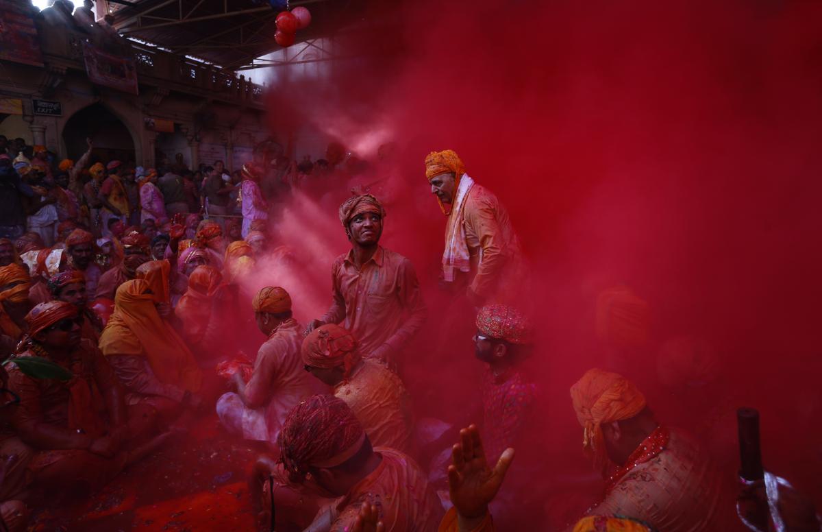 Hindu men from the village of Nandgaon threw colored powder at each other before joining a procession for the Lathmar Holi festival at the legendary hometown of Radha, consort of Hindu God Krishna, in Barsana, India, on Feb 27. (Saurabh Das/Associated Press)