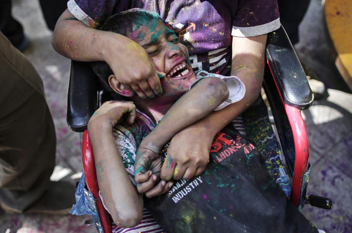 Children covered in colored powder played during celebrations of Holi at the Society for the Education of the Crippled in Mumbai on March 4. (Danish Siddiqui/Reuters)