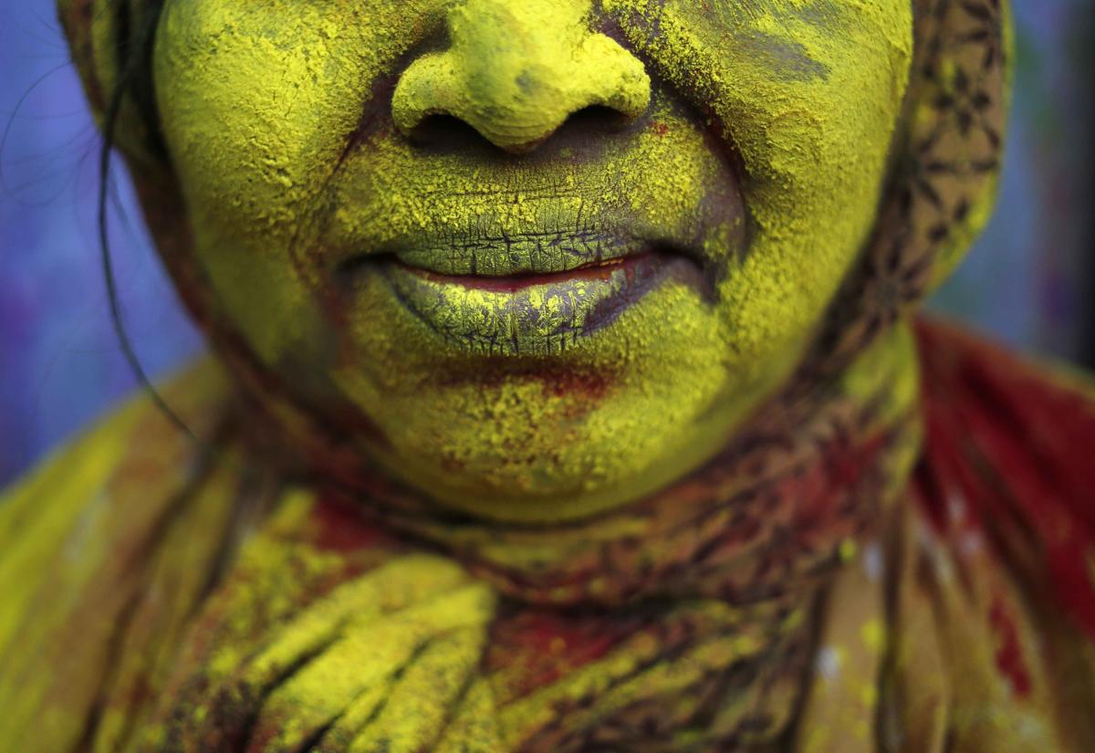 The face of a widow was daubed in color after the Holi celebrations at Vrindavan on March 4. (Anindito Mukherjee/Reuters)