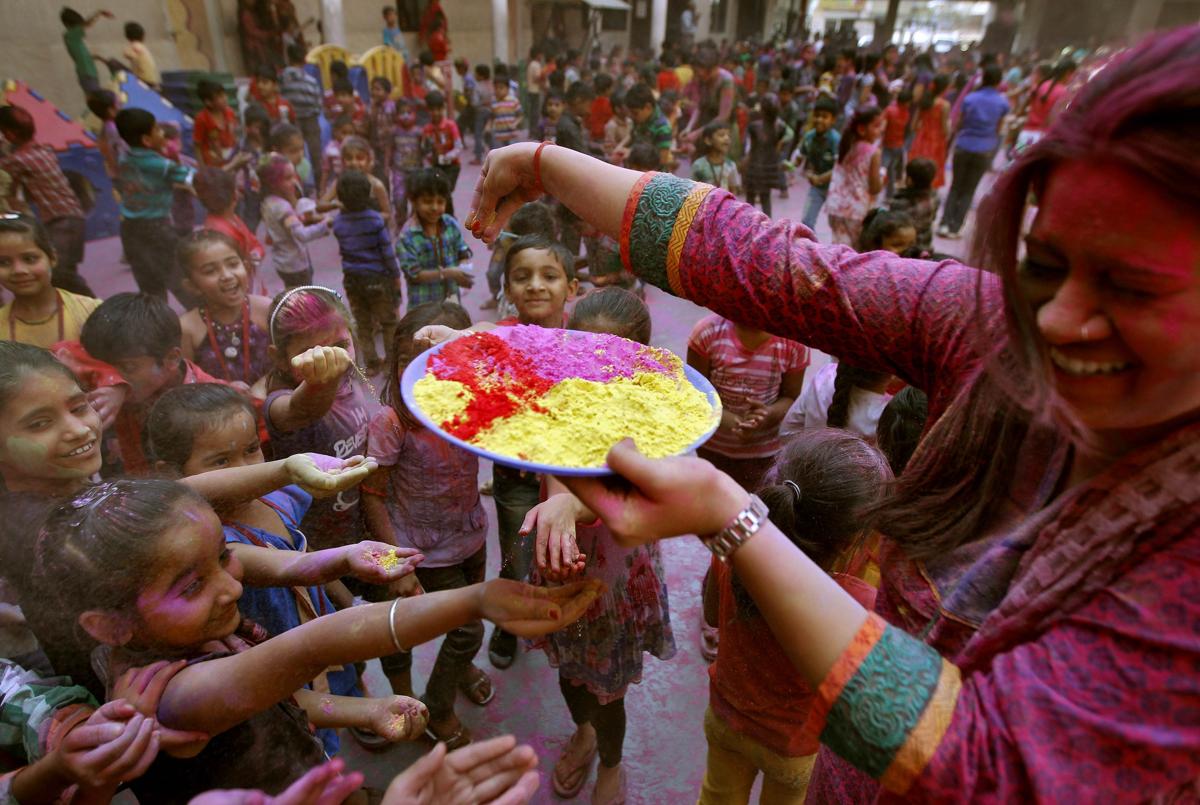 Water fell on the colored hand of a man dancing during Holi celebrations in Gauhati, India, on March 6. (Anupam Nath/Associated Press)