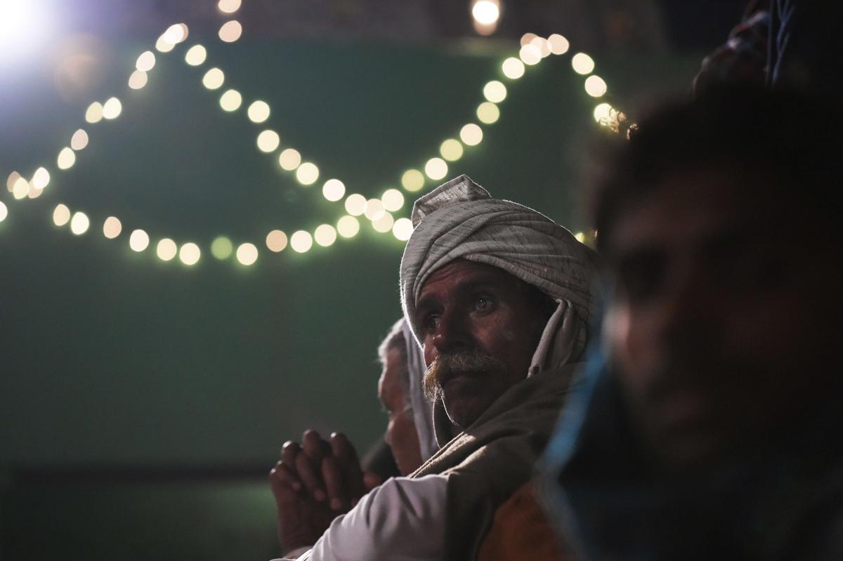 An Indian villager waited near a Hindu temple as a priest readied himself to run through a huge bonfire in the northern town of Phalem on March 6. Hundreds of villagers from the farming town crowded rooftops and a small square as the priest walked through a raging fire in a ritual that marks the burning of demon Holika. (Roberto Schmidt/AFP/Getty Images)