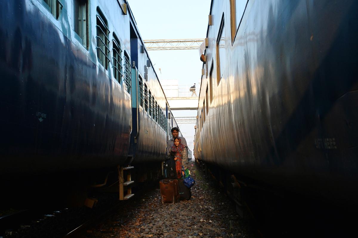 An Indian married couple stood waited to cross the railway tracks on arrival in their hometown for festival holidays in Allahabad on March 6. Indian Railways runs special trains to meet the demand for travel during the Holi Festival. (Chandan Khanna/AFP/Getty Images)
