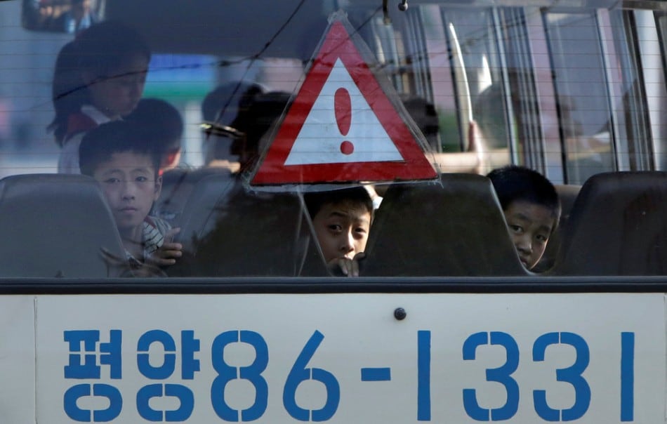 North Korean students travel in a school bus in Pyongyang July 25, 2013. (Photo by Jason Lee/Reuters)