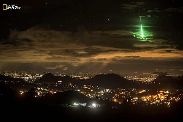 Prasenjeet Yadav/2016 National Geographic Nature Photographer of the Year. Serendipitous Green Meteor. Honorable Mention—Landscape: Anand Varma was visiting me and I was showing him around a mountain range in South India called the Western Ghats. We camped on the side of a road and I set up my Nikon D600 and a 24-70mm lens to take 15-second exposures. I set the camera to take 999 images. I slept next to the camera and it continued taking pictures until dawn. It wasn’t until the next afternoon that I reviewed my images and noticed something unusually bright and green. I showed it to Anand, and we realized that I had captured an extremely rare event. After checking with a few experts, I learned that it was a green meteorite, and getting it on camera is very rare. This is an example of being at the right place at the right time to capture something totally unexpected. For those 15 seconds, I was the luckiest photographer on the planet.