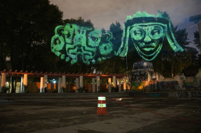 Dioses del Maíz (Corn Gods): Prehispanic 3D Gods projected on trees against transgenic corn.