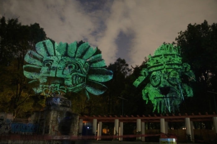 Dioses del Maíz (Corn Gods): Prehispanic 3D Gods projected on trees against transgenic corn.