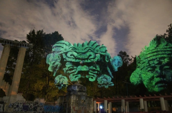 Dioses del Maíz (Corn Gods): Prehispanic 3D Gods projected on trees against transgenic corn.