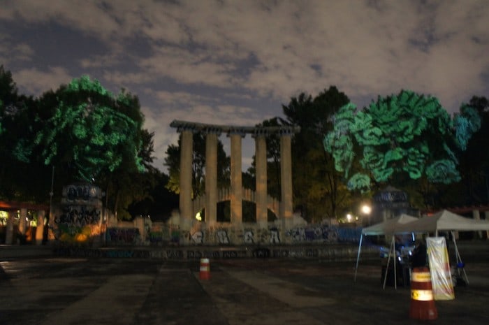 Dioses del Maíz (Corn Gods): P rehispanic 3D Gods projected on trees against transgenic corn.