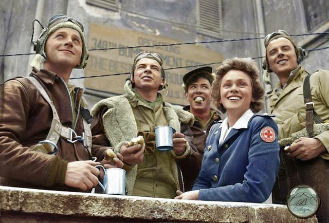 From Left to Right, B-25 crew members: Sgt. John C. Bellendir (Gnr.), Chicago; Sgt. Raymond J. Swingholm (Eng/Gnr.), Lebanon, PA; Sgt. Harris B. Pate (Rd/Gnr.), Hamlet, NC; Red Cross Clubmobile Worker, Peggy Steers from White Plains, NY. and T/Sgt. Aubrey Chatters (Rd/Gnr.), Milington MI. All from the 321st Bombardment Group, 447th Bombardment Squadron,12th Air Force. Alesani Airfield, Corsica, 2nd of July 1944. (Photographer - Ollie Atkins, reporter for the American Red Cross. Colorized by Lori Lang from America)