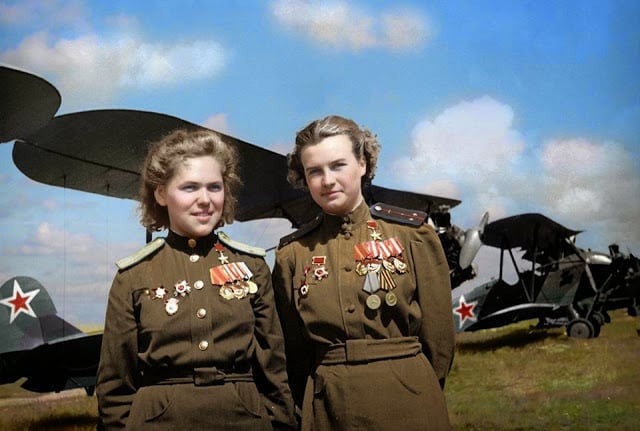 Soviet Air Force officers, Rufina Gasheva (848 night combat missions) and Nataly Meklin (980 night combat missions) decorated as 'Heroes of the Soviet Union' for their service with the famed 'Night Witches' unit during World War II. They stand in front of their Polikarpov Po-2 biplanes. (Colourisation and research by Olga Shirnina from Russia)