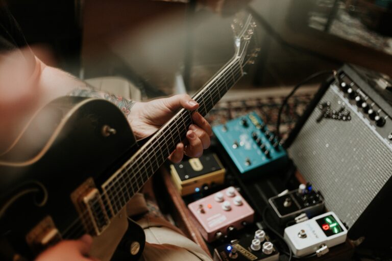 a hand holding a guitar