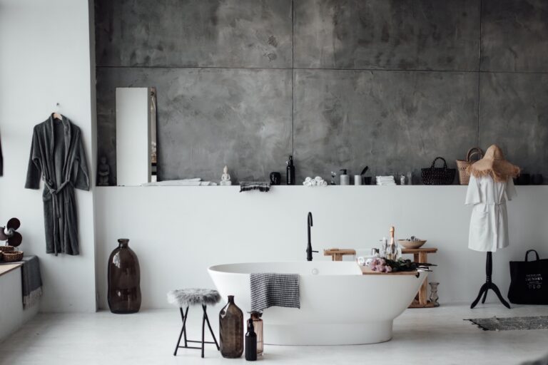 a person in a room with a sink and a mirror