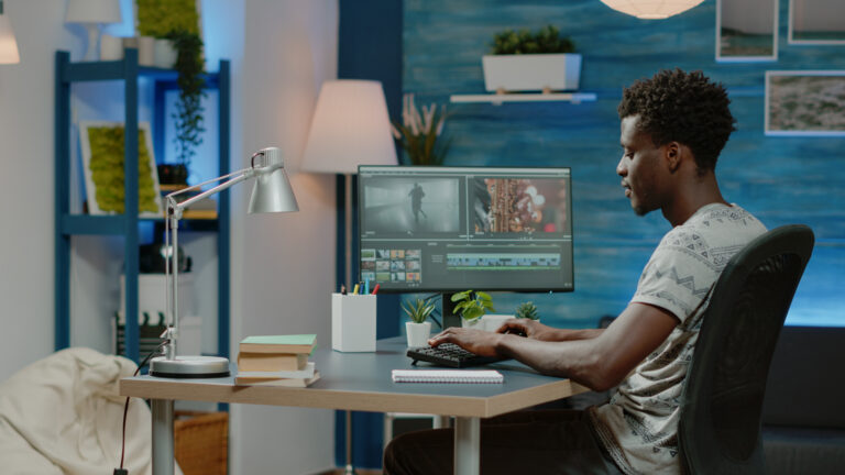 a man sitting at a table using a laptop