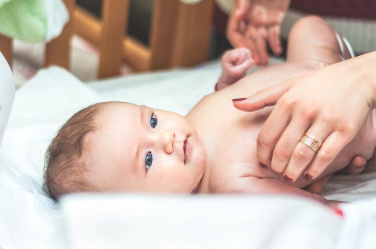 a baby lying on a bed
