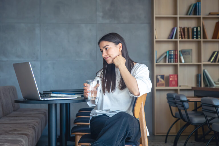a person sitting in a chair talking on the phone